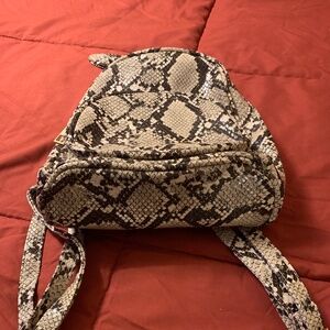 Snake like mini bagpack carry case with stripes with Bow in back - Pre-owned